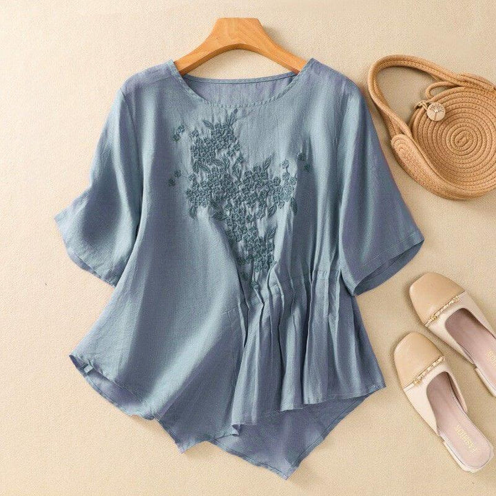 Relaxed Embroidered Blouse with Asymmetrical Hem and Soft Pleated Detail